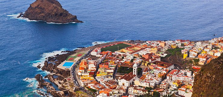 Rocky Tenerife coastline, red roofed houses, from above