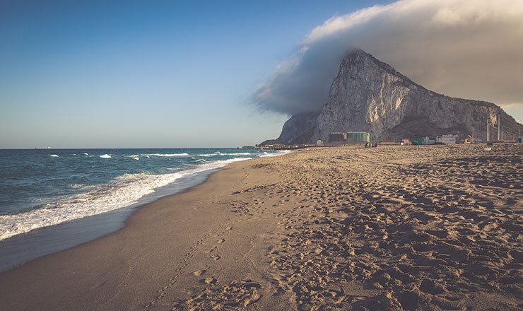 A beach in Gibraltar with rock